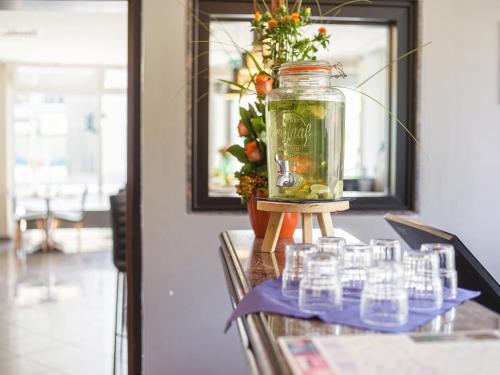 a jar filled with water sitting on top of a table at Hotel Berlin Mitte by Campanile in Berlin