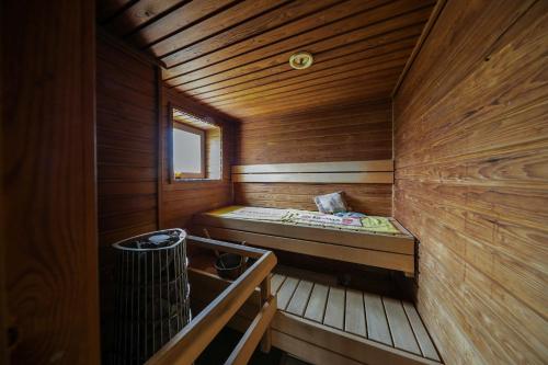 a small wooden sauna with a bed in it at Hulda`s Apartment by the river in Heinola