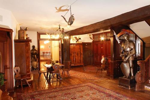 a living room with a statue in the middle of it at Hotel Rheinfels in Stein am Rhein