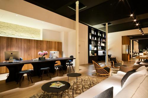 a living room with a couch and a table at Yurbban Passage Hotel & Spa in Barcelona