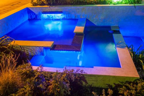 a swimming pool in a backyard at night at Vila Opera in Vrnjačka Banja