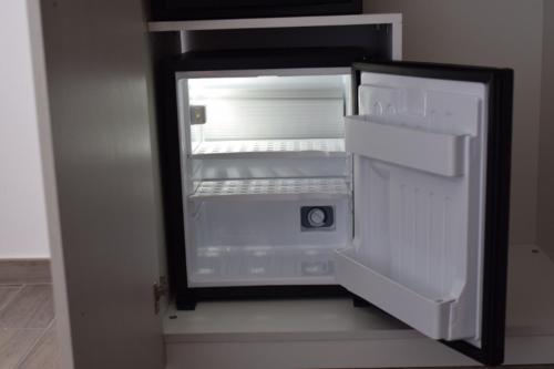 an empty refrigerator with its door open in a room at Lvresidence Roccelletta in Catanzaro Lido