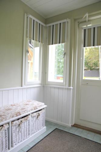 a room with two windows and a bed in it at Karu Holiday Home in Laiusevälja