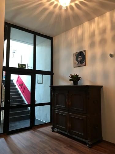 a room with a large glass door and a staircase at SmartHotel Mystique Self check-in in Bad Homburg vor der Höhe