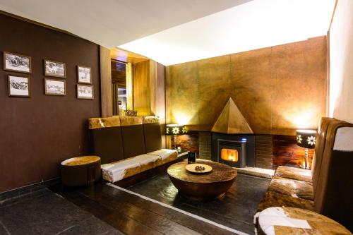 uma sala de estar com um sof� e uma lareira em Luna Hotel Serra da Estrela na Covilh�