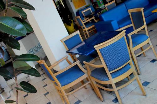 a group of chairs and a table in a restaurant at Hotel Bristol - a 30 mt dalla spiaggia in Misano Adriatico