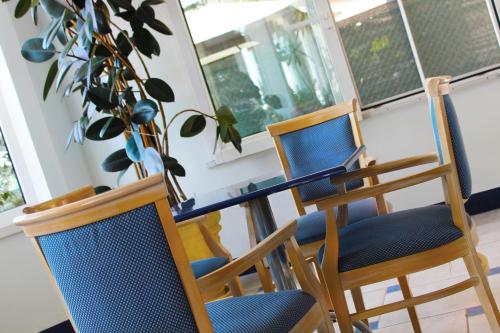 a dining room with a table with a laptop on it at Hotel Bristol - a 30 mt dalla spiaggia in Misano Adriatico