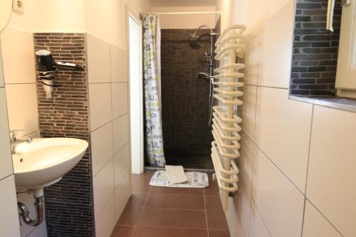 a small bathroom with a sink and a shower at Ferienwohnung Seerose mit Terrasse in Sassnitz