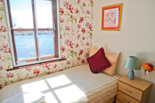 a small bedroom with a bed and a window at The Herons Rest Townhouse B&B in Galway