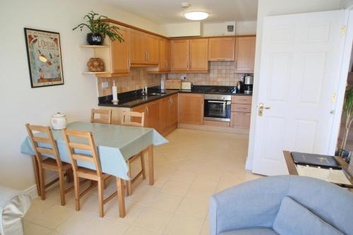 a kitchen with a table and a blue chair at The Herons Rest Townhouse B&B in Galway