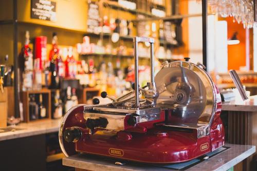 a red blender sitting on top of a bar at Enjoy 1313AG Hotel Touring in Chiasso