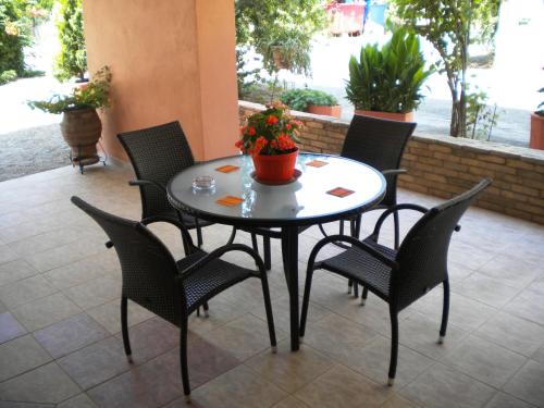 エディプソスにあるTsakalos Apartmentsのテーブル、椅子、植物のあるパティオ
