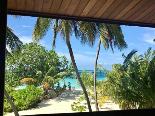 a view of the beach from a resort window at Iru Maldives in Thulusdhoo