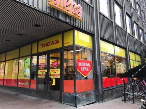 a store front of a building with signs in the windows at CheapSleep Hostel Helsinki in Helsinki