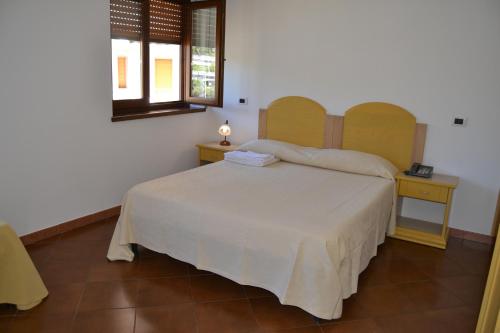 a bedroom with a bed and a table and a window at A Casa Di Luca in Diamante