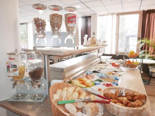 a kitchen with baskets of food on a counter at Brit Hotel Lille Centre in Lille