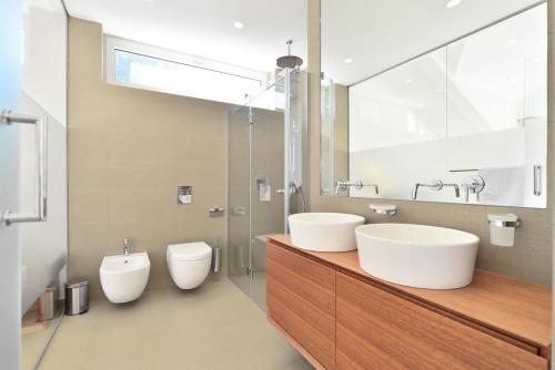 a bathroom with two sinks and two toilets at Chiponsky One - 5 star beachfront property in Bol