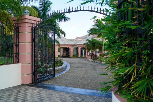 an entrance to a house with an iron gate at Villa Dora Mae in Ocho Rios