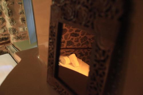 a reflection of a bathroom with a toilet in a mirror at Bayiri Petit Pension in Litochoro