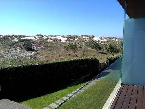 a view from the balcony of a house with a yard at T2 Dunas Esposende in Esposende