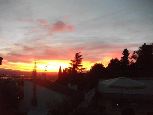 a sunset from the roof of a building at Hotel Los Rebites in Huétor Vega