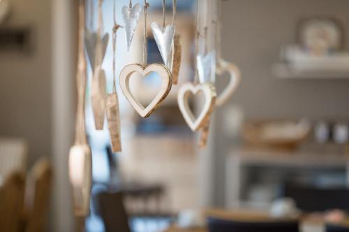 a group of hearts hanging on a wall at Hotel Restaurant Am Kellhof in Singen