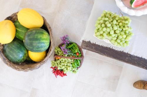 two baskets of fruit and vegetables on a table at Masseria Fontana di Vite in Matera
