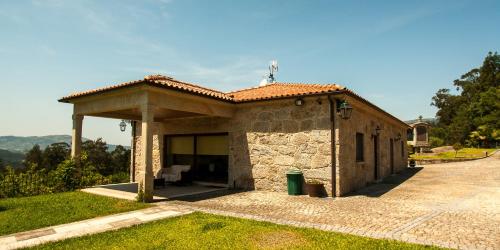a small stone building with a roof at Quinta da Toural in Arcos de Valdevez