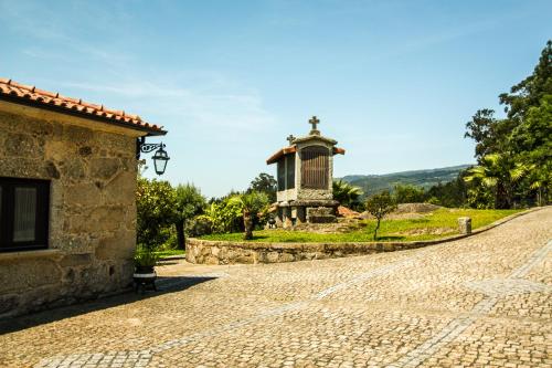 a cobblestone street with a monument in the distance at Quinta da Toural in Arcos de Valdevez