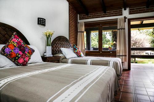 Кровать или кровати в номере Finca Mexicana