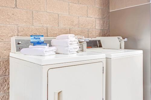 a pile of towels on top of a washer and dryer at Days Inn by Wyndham Bradenton - Near the Gulf in Bradenton