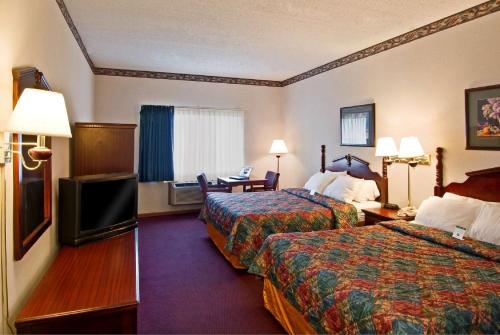 a hotel room with two beds and a flat screen tv at Americas Best Value Inn Waukegan in Waukegan