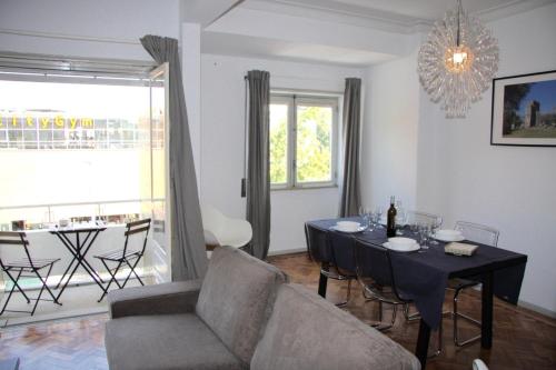 a living room with a table and a couch at Old Market Place in Guimarães