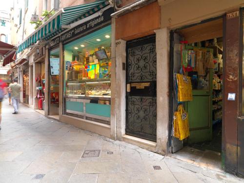 a shop with a door on the side of a street at Casa Fantasy in Venice