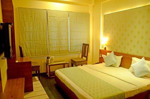 Una cama o camas en una habitación de Hotel Shalimar Palace