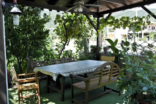 a table and chairs sitting under a pergola at Roula Rooms in Stratoni