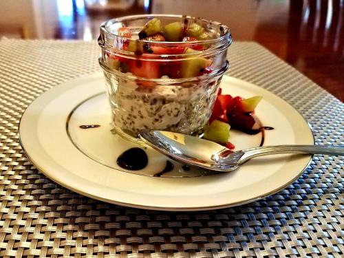 a plate with a jar of food with a spoon at Carriage Corner Bed & Breakfast in Gordonville
