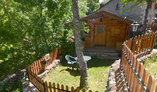 Cabaña de madera con mesa y valla en CABAÑAS LAGO DE SANABRIA, en Vigo de Sanabria