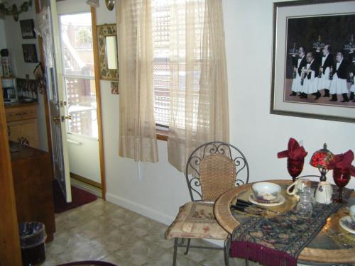 a dining room with a table and chairs and a window at 1 Murray House in Newport