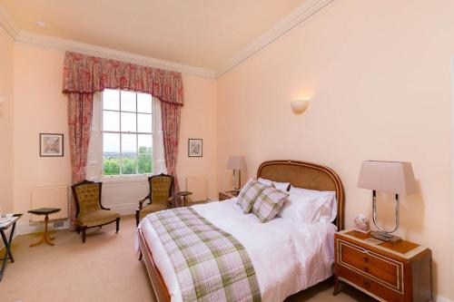a bedroom with a bed and a window at Blervie House in Forres