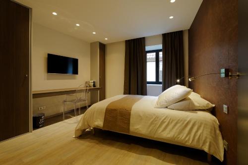 Ένα ή περισσότερα κρεβάτια σε δωμάτιο στο The One Apartments