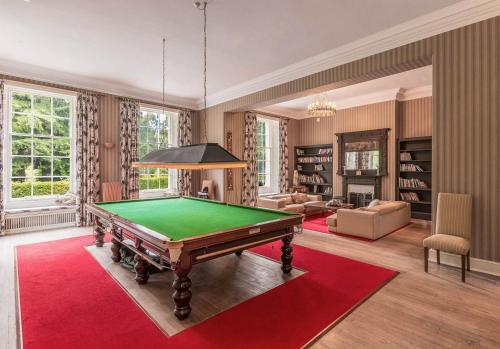 a living room with a pool table in it at Blervie House in Forres