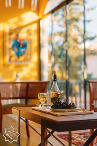 a table with a bottle of wine and a glass at Delight Deluxe Hotel in Antalya