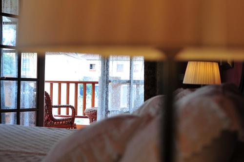 a person laying in a bed looking at a window at Hotel Emblemático San Marcos in Icod de los Vinos