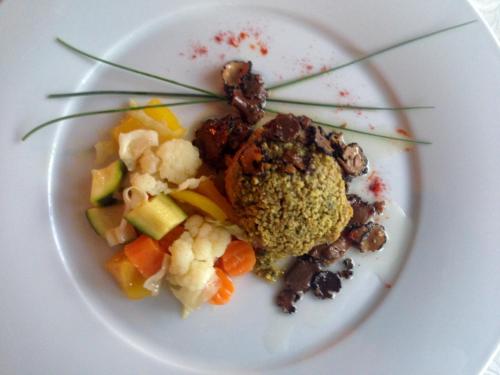a white plate of food with vegetables on it at Hotel Gran Paradiso in San Cassiano