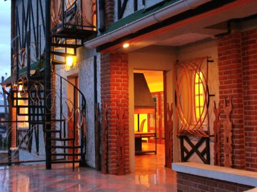 an entrance to a brick building with a fire escape at Marciloui in Antsirabe