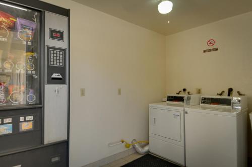 a kitchen with a refrigerator and a microwave at Vagabond Inn Hacienda Heights in Hacienda Heights