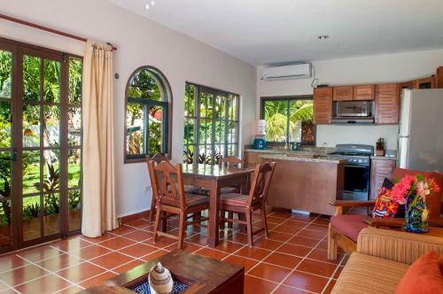 a kitchen and living room with a table and chairs at Casa Anita - Relaxing Home Steps from the Puerto Morelos Beach in Puerto Morelos