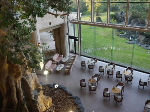an overhead view of a restaurant with tables and chairs at Yakushima Iwasaki Hotel in Yakushima