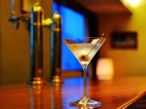 a martini glass sitting on top of a wooden table at Hotel Crown Palais Hamamatsu in Hamamatsu